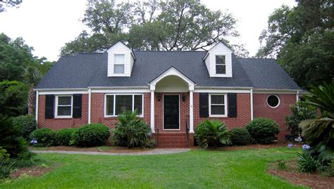 metal houses with brick|matching brick and roof colors.